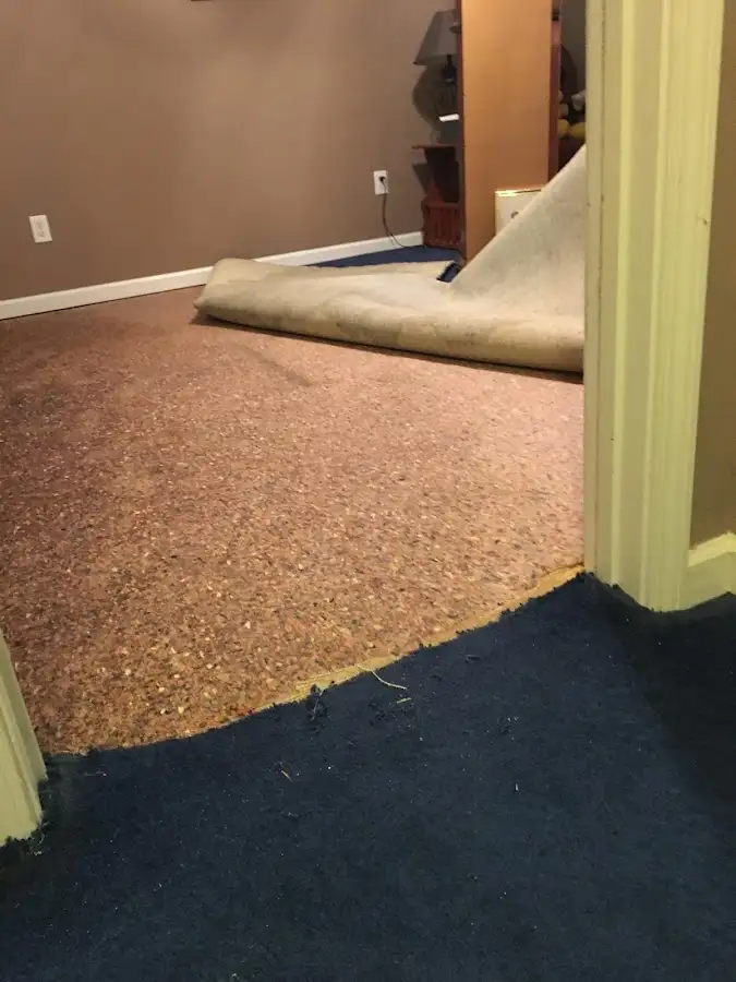 Carpet pad removal revealing water damage during Water Mitigation Services in Amarillo